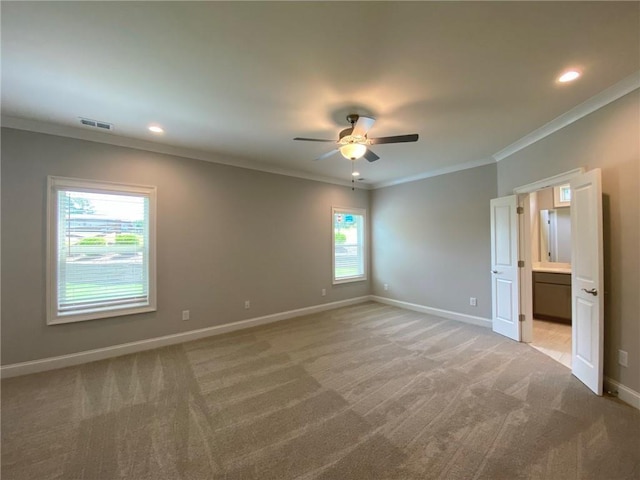 unfurnished bedroom with ceiling fan, carpet flooring, crown molding, and connected bathroom