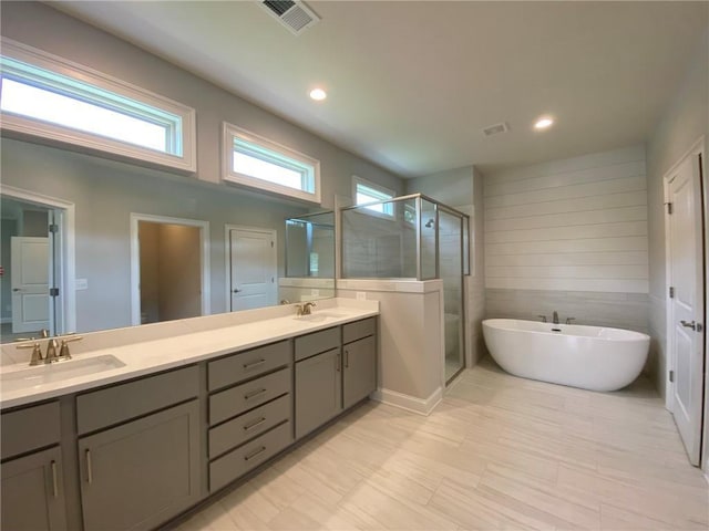 bathroom with plus walk in shower and vanity