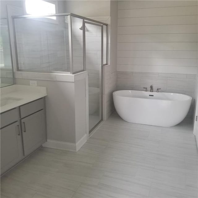 bathroom with vanity and plus walk in shower