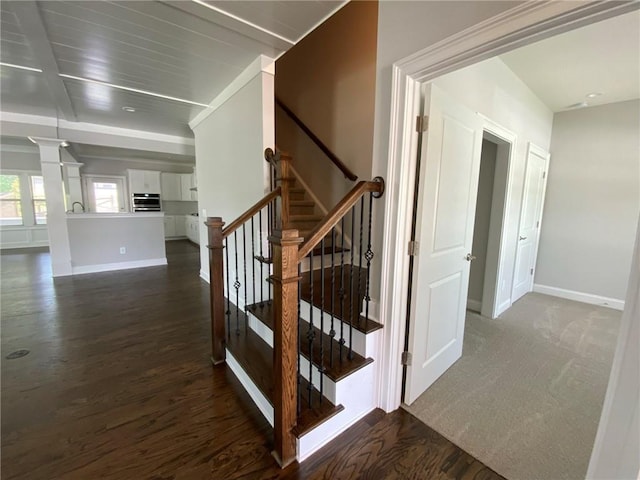 stairs featuring sink and wood-type flooring