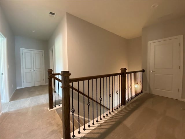 hallway with light carpet