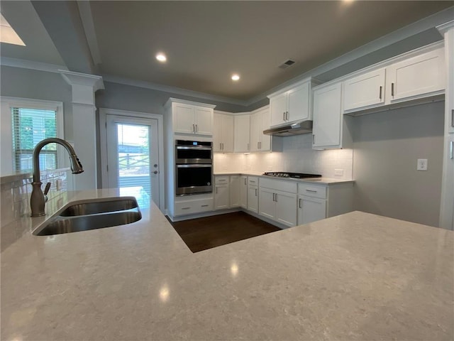 kitchen featuring sink, white cabinetry, appliances with stainless steel finishes, and tasteful backsplash