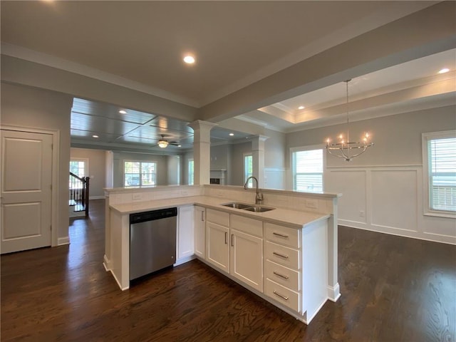 kitchen with white cabinetry, plenty of natural light, decorative light fixtures, stainless steel dishwasher, and sink