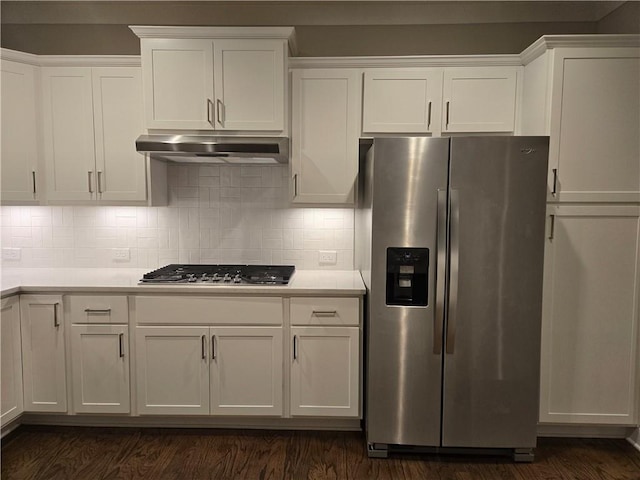 kitchen with white cabinets, decorative backsplash, appliances with stainless steel finishes, and dark hardwood / wood-style floors