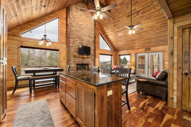 kitchen with wooden walls, plenty of natural light, wooden ceiling, and hardwood / wood-style flooring