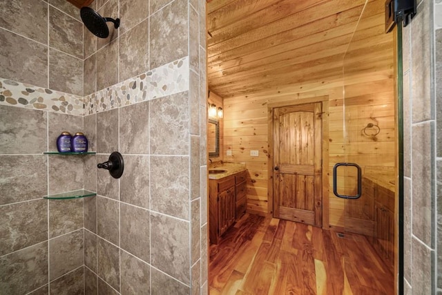 full bathroom with vanity, wood finished floors, a stall shower, and a sauna