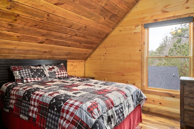 bedroom with wood ceiling, wooden walls, wood finished floors, and vaulted ceiling