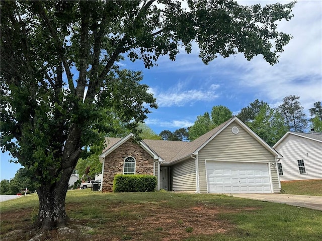view of front of home featuring a shingled roof, concrete driveway, stone siding, a front yard, and a garage