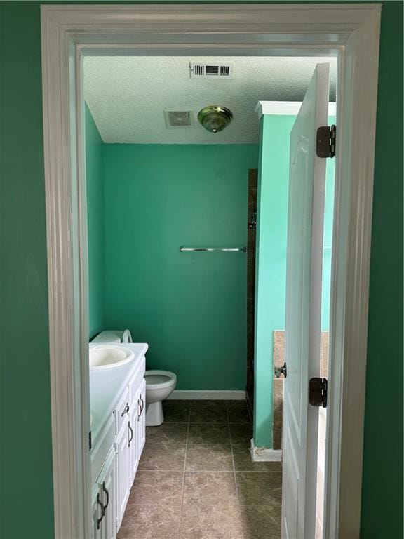 full bathroom with visible vents, baseboards, vanity, and toilet