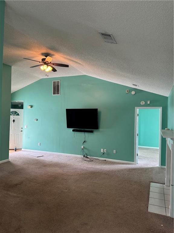 unfurnished living room with lofted ceiling, visible vents, carpet, and ceiling fan