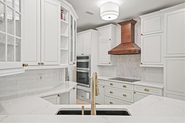 230 Bristol Stone Ct, Johns Creek, GA 30005 - kitchen with wall chimney range hood, open shelves, a sink, black electric cooktop, and tasteful backsplash