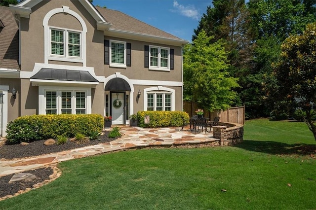 230 Bristol Stone Ct, Johns Creek, GA 30005 - view of front of house featuring stucco siding, a front lawn, a patio area, and a standing seam roof