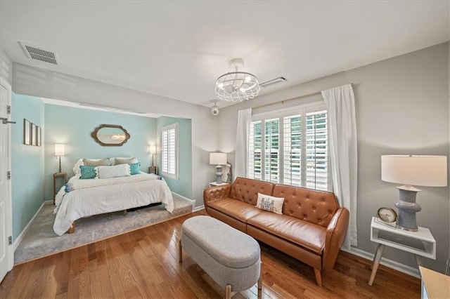 230 Bristol Stone Ct, Johns Creek, GA 30005 - bedroom with a chandelier, baseboards, and wood finished floors