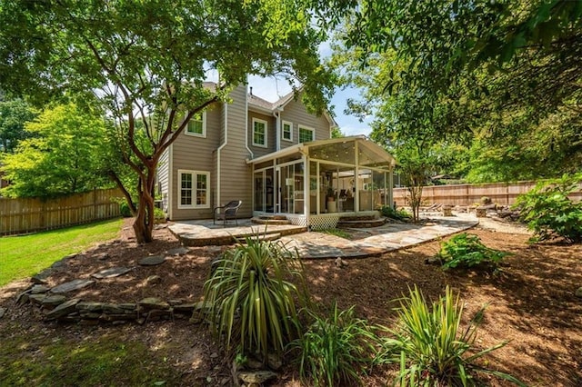 230 Bristol Stone Ct, Johns Creek, GA 30005 - rear view of house featuring a sunroom, a patio area, a fenced backyard, and a chimney