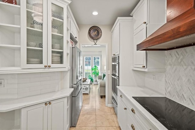 230 Bristol Stone Ct, Johns Creek, GA 30005 - kitchen featuring wall chimney range hood, white cabinets, stainless steel appliances, tasteful backsplash, and light tile patterned floors