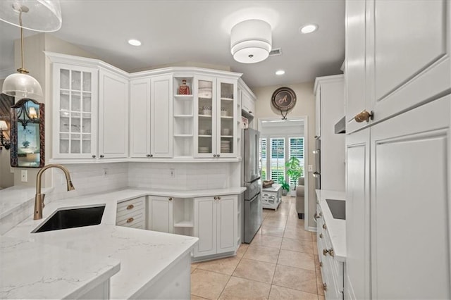 230 Bristol Stone Ct, Johns Creek, GA 30005 - kitchen featuring a sink, freestanding refrigerator, backsplash, light tile patterned floors, and light stone countertops