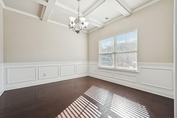 unfurnished room with dark wood-type flooring, beam ceiling, coffered ceiling, and a chandelier