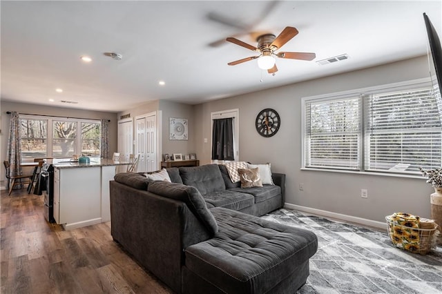 living area featuring baseboards, visible vents, a ceiling fan, wood finished floors, and recessed lighting