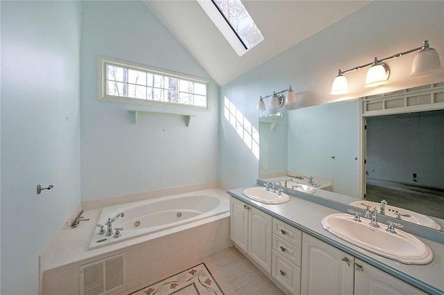 full bath with a sink, visible vents, double vanity, a tub with jets, and lofted ceiling with skylight