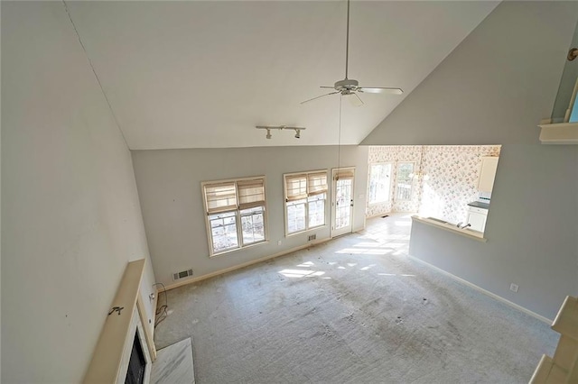 unfurnished living room with a ceiling fan, light colored carpet, visible vents, and baseboards