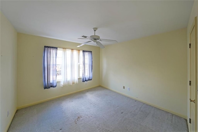 unfurnished room with carpet flooring, ceiling fan, visible vents, and baseboards