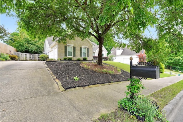 3320 Goldmist Dr, Buford, GA 30519 - view of property hidden behind natural elements with driveway, fence, brick siding, and oil tank