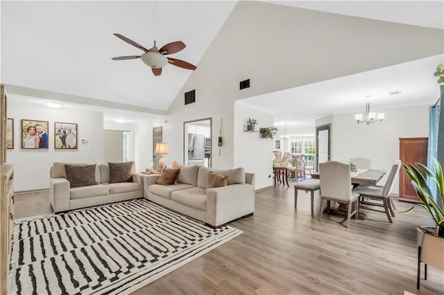 3320 Goldmist Dr, Buford, GA 30519 - living area with a chandelier, high vaulted ceiling, light wood finished floors, ceiling fan, and baseboards