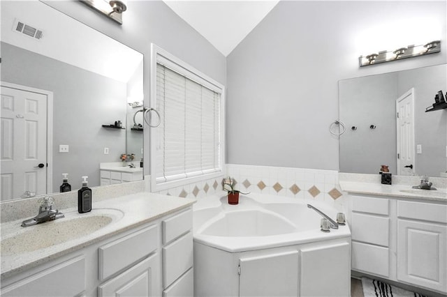 3320 Goldmist Dr, Buford, GA 30519 - full bath with vaulted ceiling, a garden tub, and two vanities