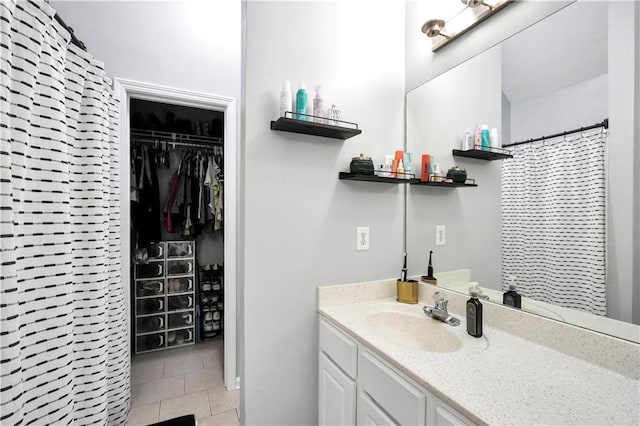 3320 Goldmist Dr, Buford, GA 30519 - bathroom featuring tile patterned flooring, vanity, a walk in closet, and a shower with shower curtain