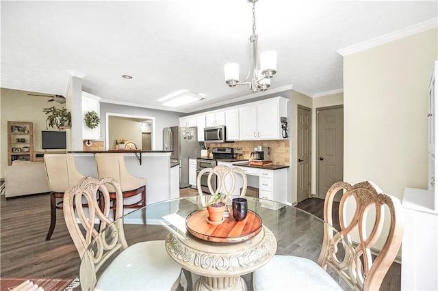3320 Goldmist Dr, Buford, GA 30519 - dining area with dark wood-type flooring, a chandelier, and crown molding
