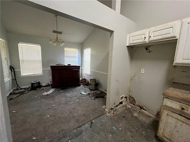 1528 Buckingham Pl, Stockbridge, GA 30281 - kitchen featuring white cabinets, a chandelier, vaulted ceiling, and hanging light fixtures