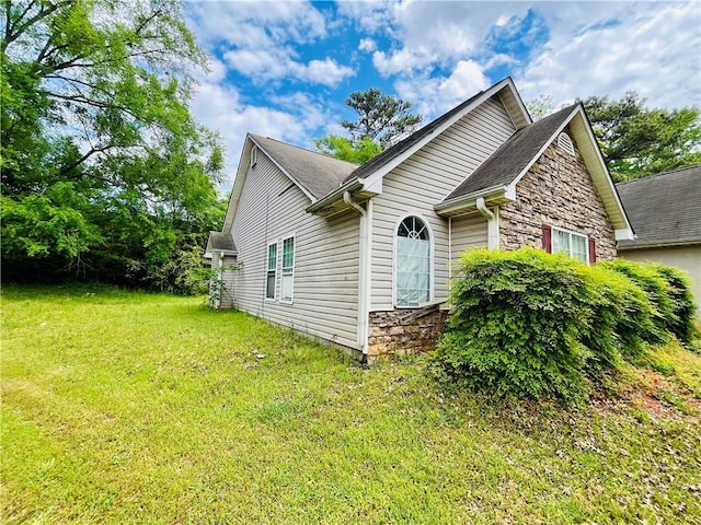1528 Buckingham Pl, Stockbridge, GA 30281 - view of home's exterior featuring stone siding, a yard, and roof with shingles