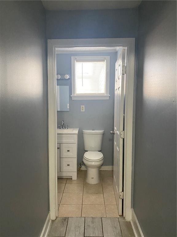 bathroom featuring hardwood / wood-style flooring, vanity, and toilet