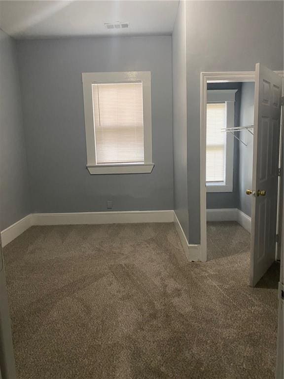 unfurnished room featuring carpet flooring