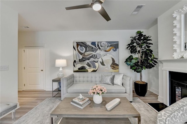 living room with hardwood / wood-style flooring and ceiling fan