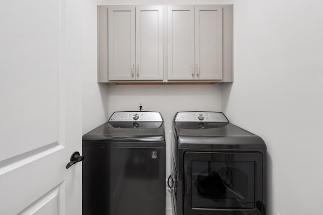 washroom with independent washer and dryer and cabinet space