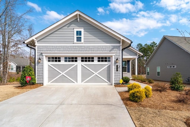 view of front of home with concrete driveway and an attached garage