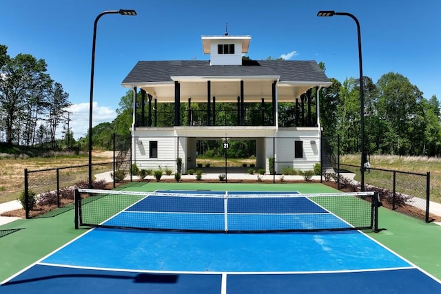 view of sport court with fence