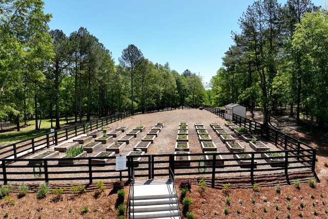 view of community featuring fence and an outdoor structure