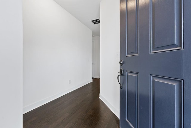 entryway featuring baseboards, visible vents, and dark wood finished floors