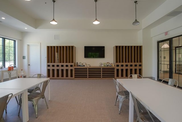 interior space featuring a tray ceiling, visible vents, and recessed lighting