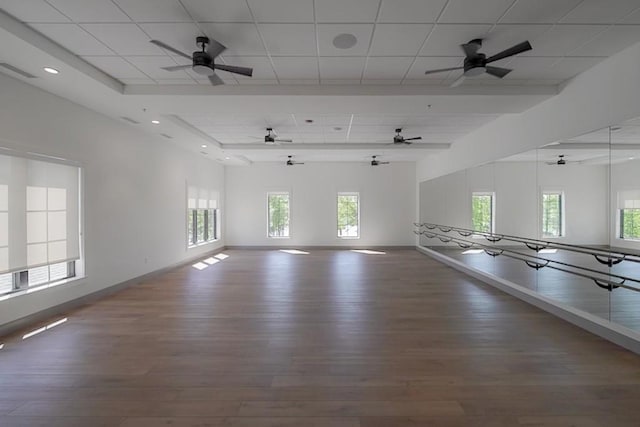 unfurnished room featuring a paneled ceiling, visible vents, baseboards, and wood finished floors