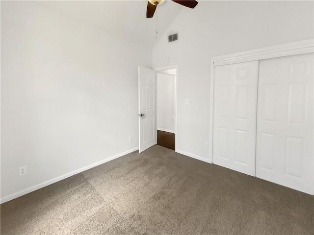 131 Morningside Dr, Jackson, GA 30233 - unfurnished bedroom featuring dark carpet, high vaulted ceiling, a closet, and ceiling fan
