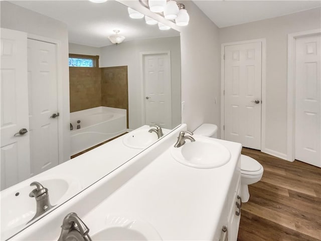 131 Morningside Dr, Jackson, GA 30233 - full bathroom with a garden tub, double vanity, and wood finished floors