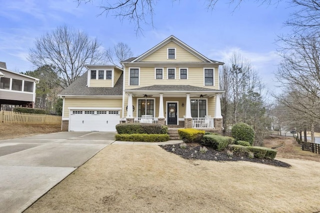 view of front of house with a shingled roof, concrete driveway, fence, a porch, and brick siding