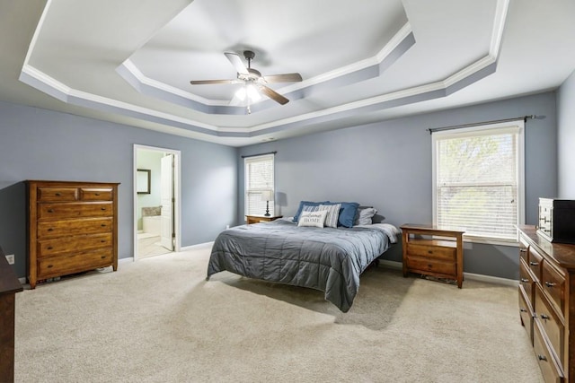 bedroom with light carpet, a tray ceiling, crown molding, and baseboards