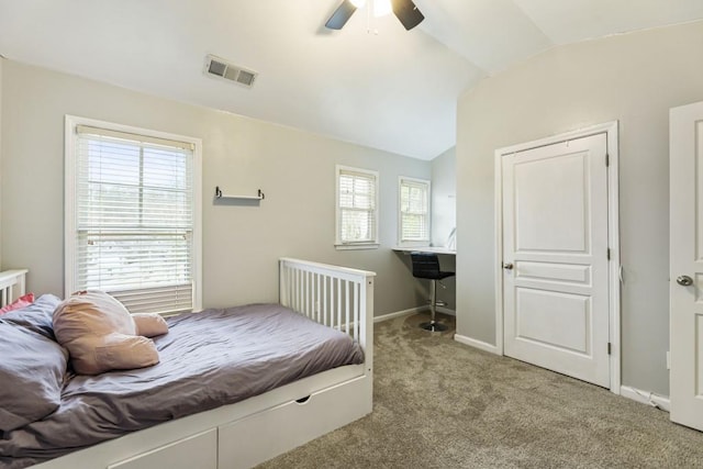 bedroom featuring light colored carpet, a ceiling fan, baseboards, vaulted ceiling, and visible vents