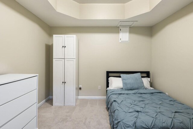 bedroom featuring baseboards and light colored carpet