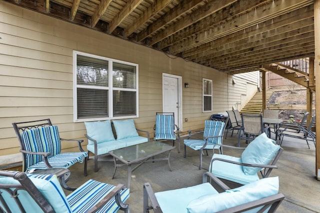 view of patio / terrace with outdoor dining area, outdoor lounge area, and stairs