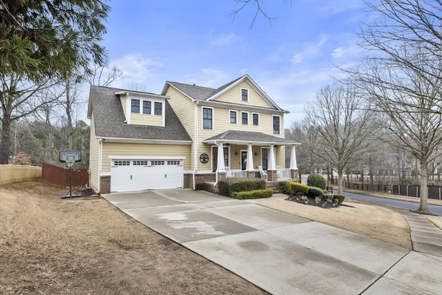 view of front of property featuring driveway, a garage, a shingled roof, fence, and a porch